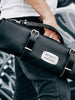 chef holding all black leather knife roll bag