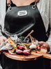 vintage leather bbq apron on chef with grilled food